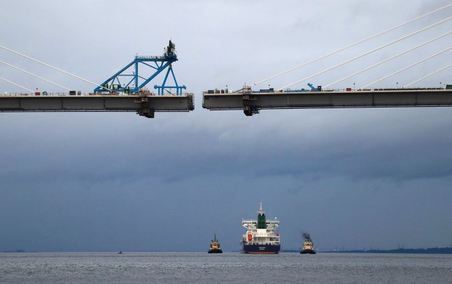 A tanker carrying US shale gas passes under the Queensferry Crossing bridge being built over the river Forth, to dock at Grangemouth, The Forth, Scotland–Photograph by Russell Cheyne